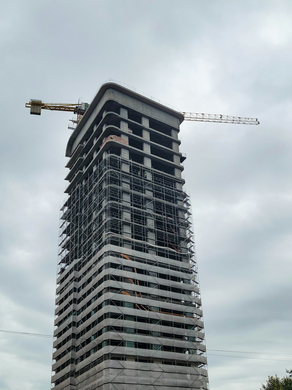 a tall building with a crane on top of it