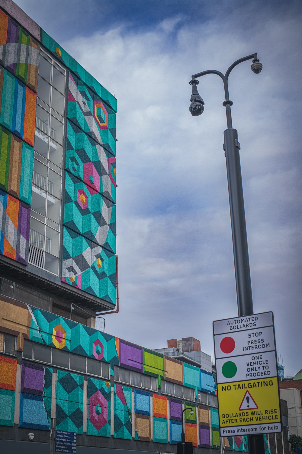 a multicolored building with a street light in front of it