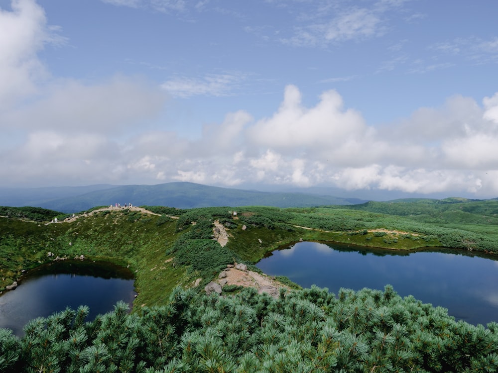 un grande specchio d'acqua circondato da lussureggianti colline verdi