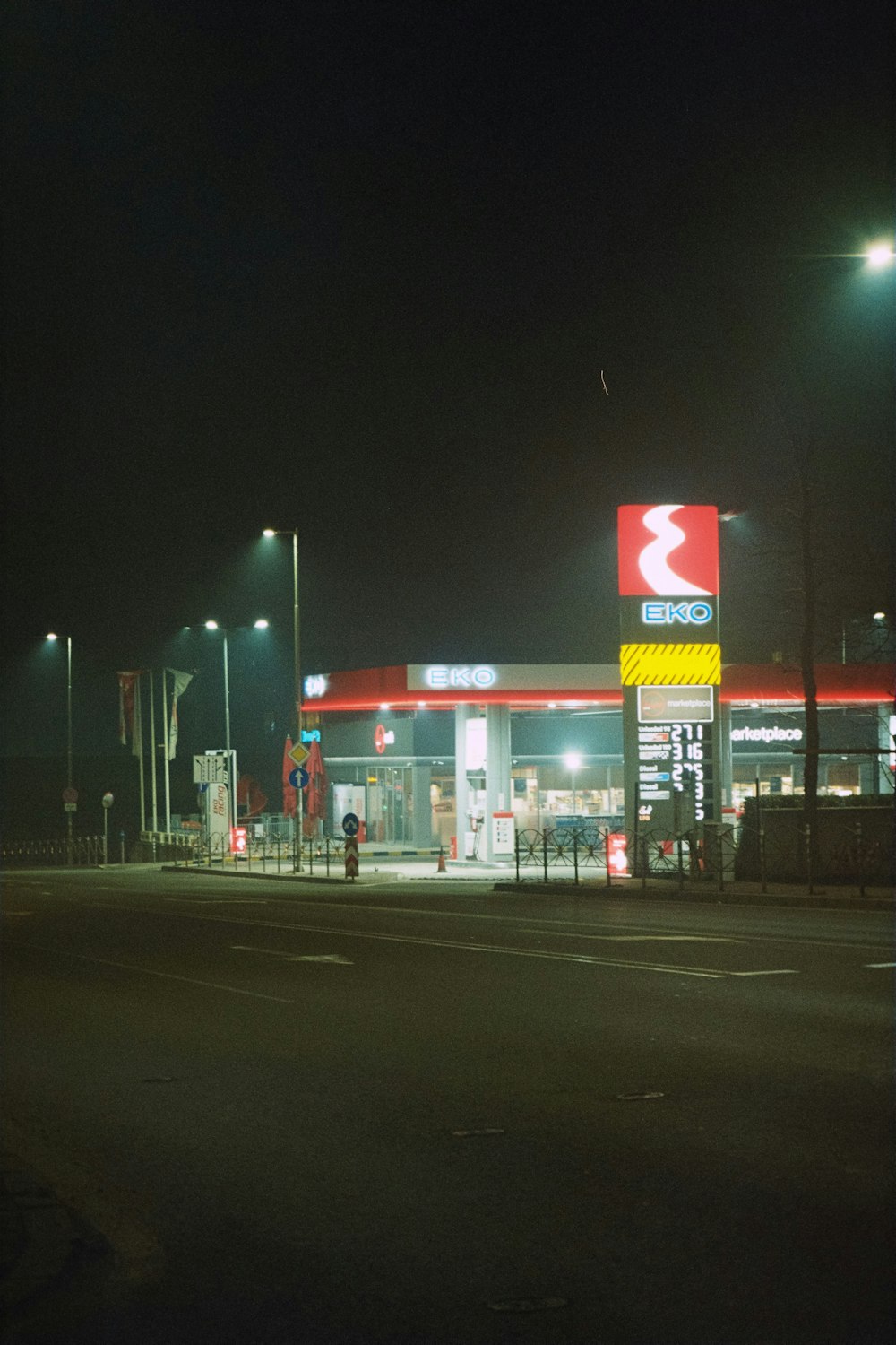 a gas station lit up at night time