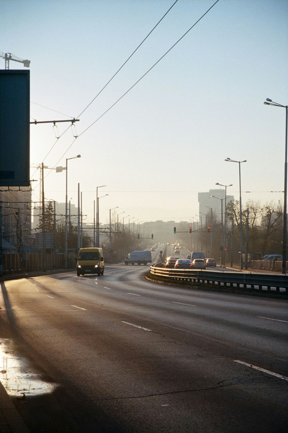 a car driving down a street next to a traffic light