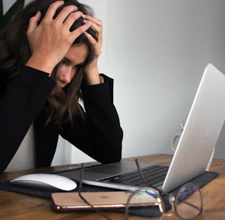 a woman sitting in front of a laptop computer
