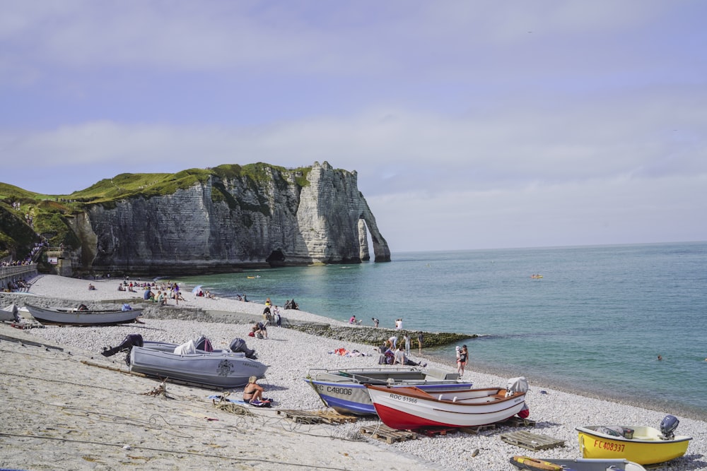 a group of boats sitting on top of a sandy beach