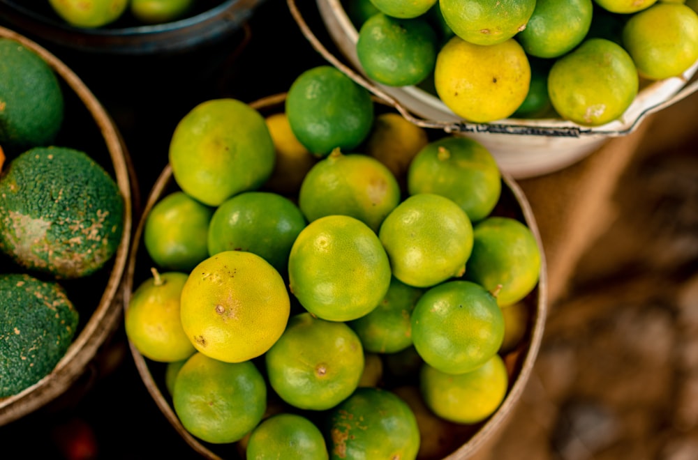 baskets of limes and cucumbers on display at a market