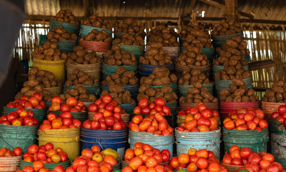 a bunch of buckets filled with lots of fruit