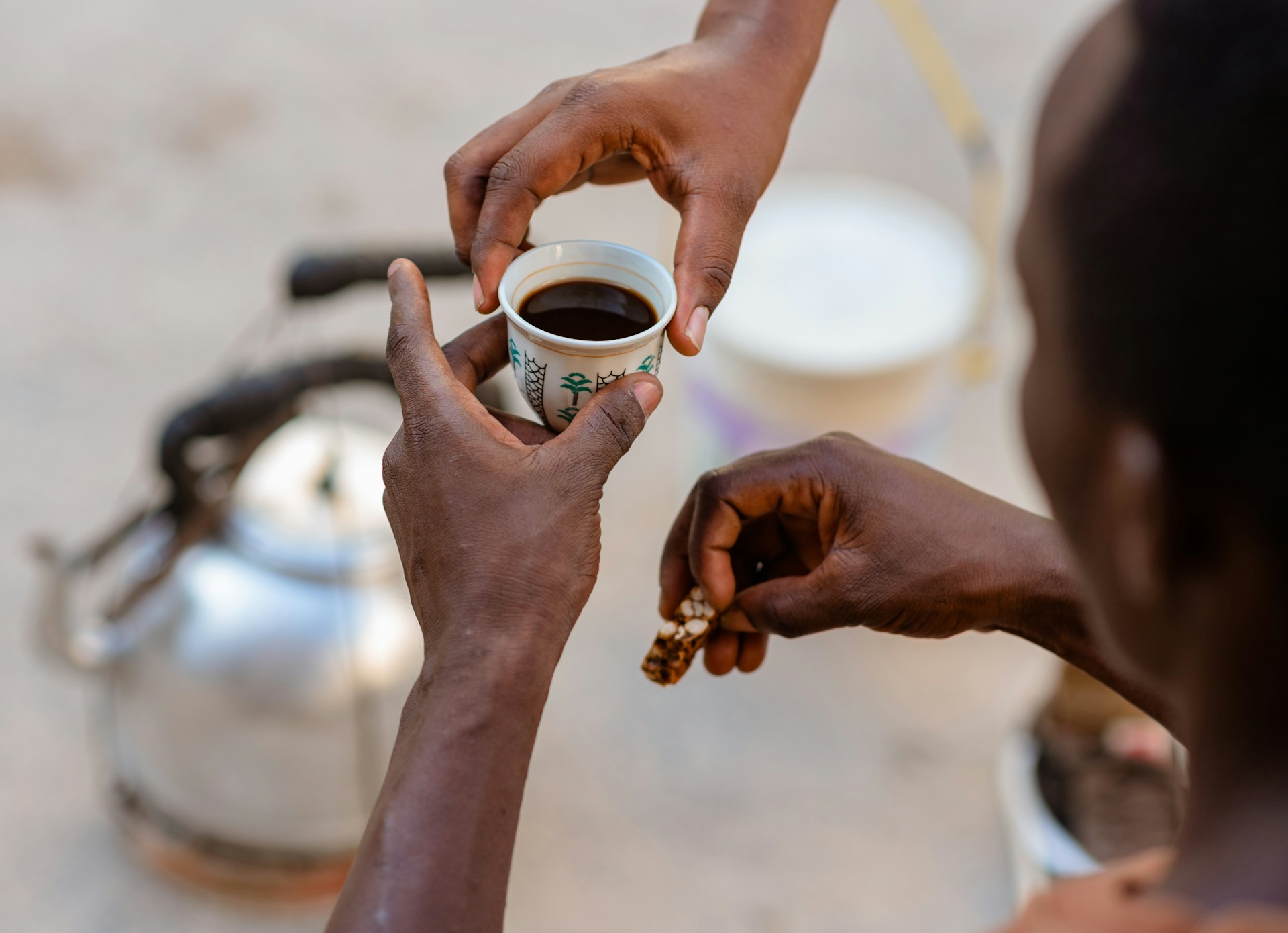 a person holding a cup of coffee in their hands