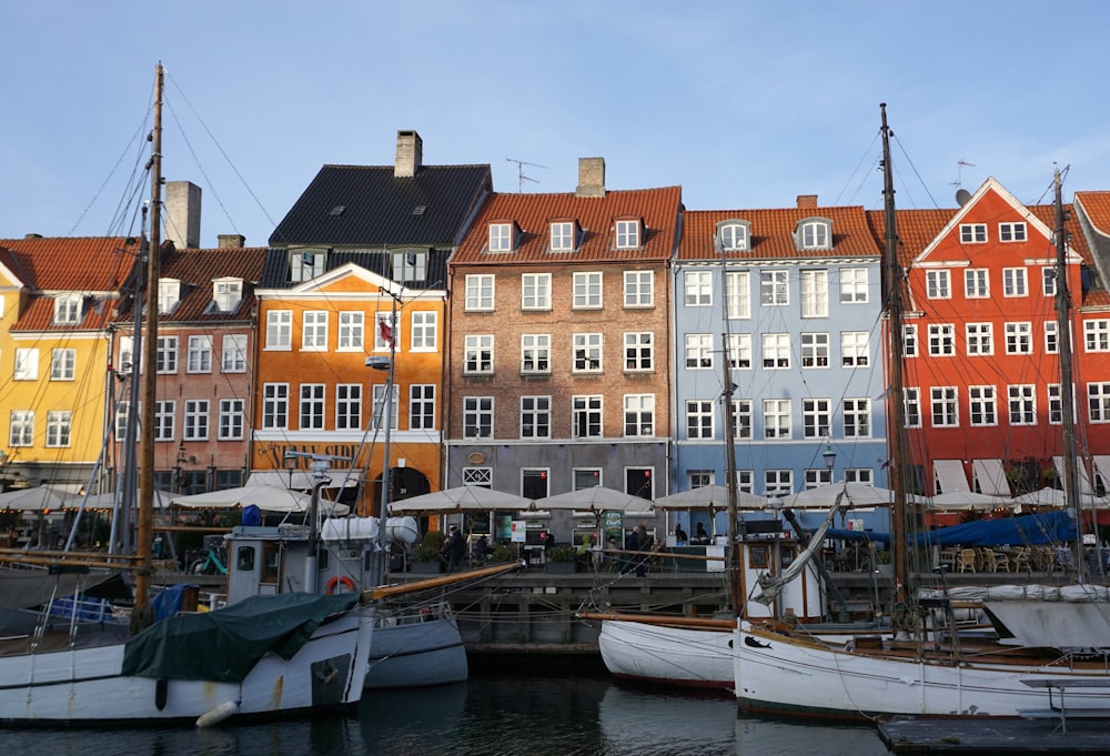 a harbor filled with lots of boats next to tall buildings