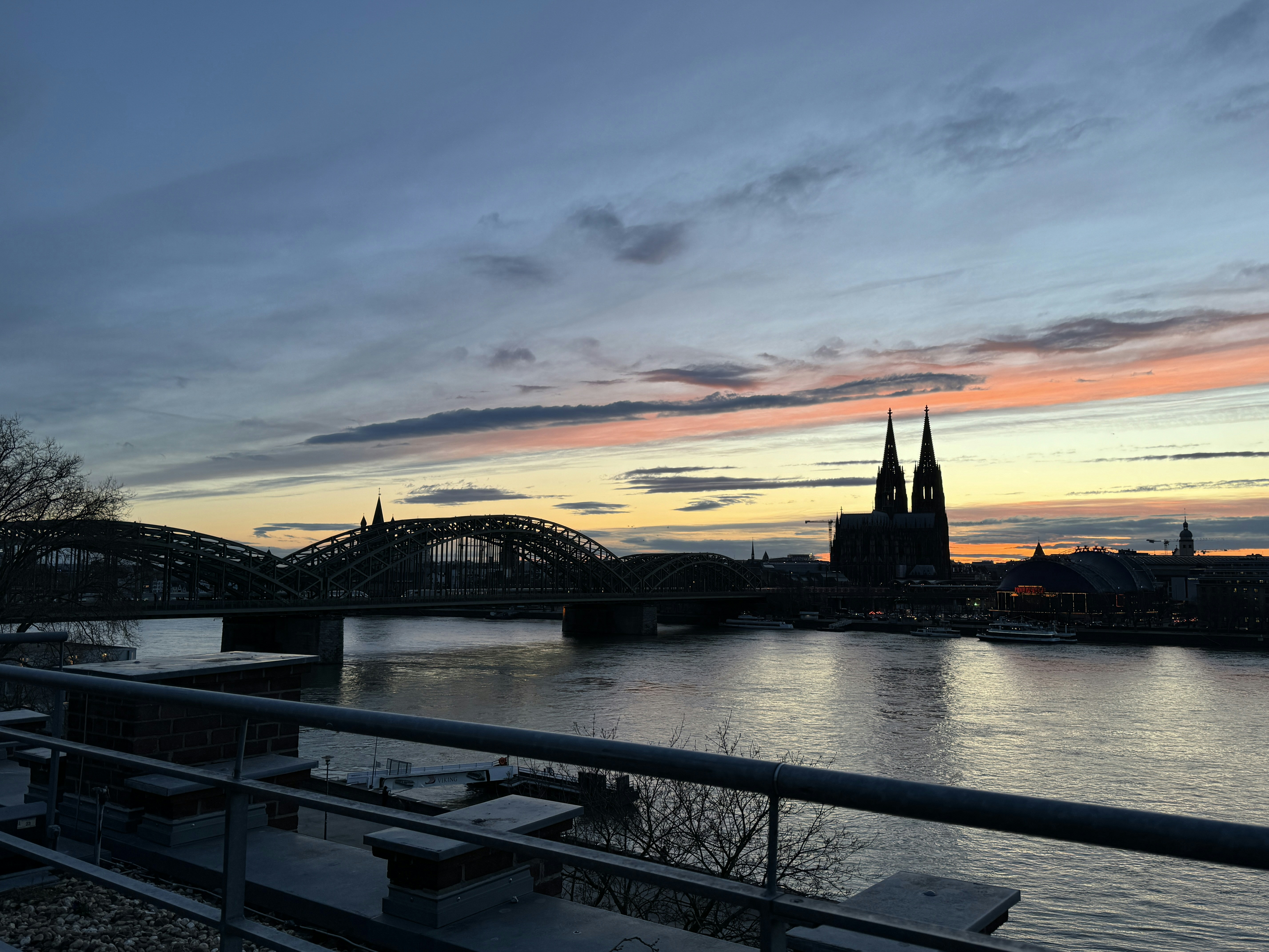 a bridge over a river with a cathedral in the background