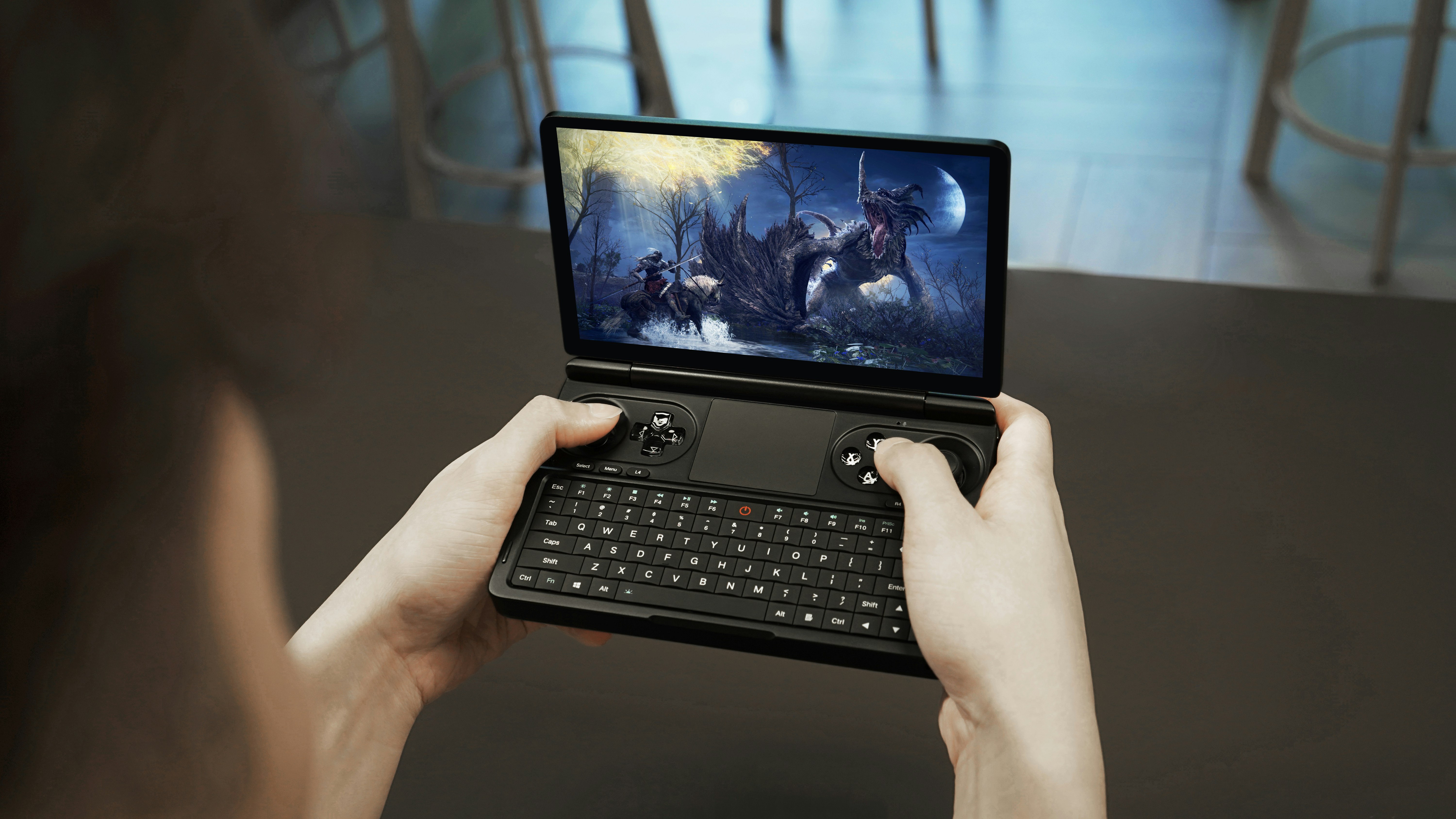 a person holding a tablet with a video game on the screen