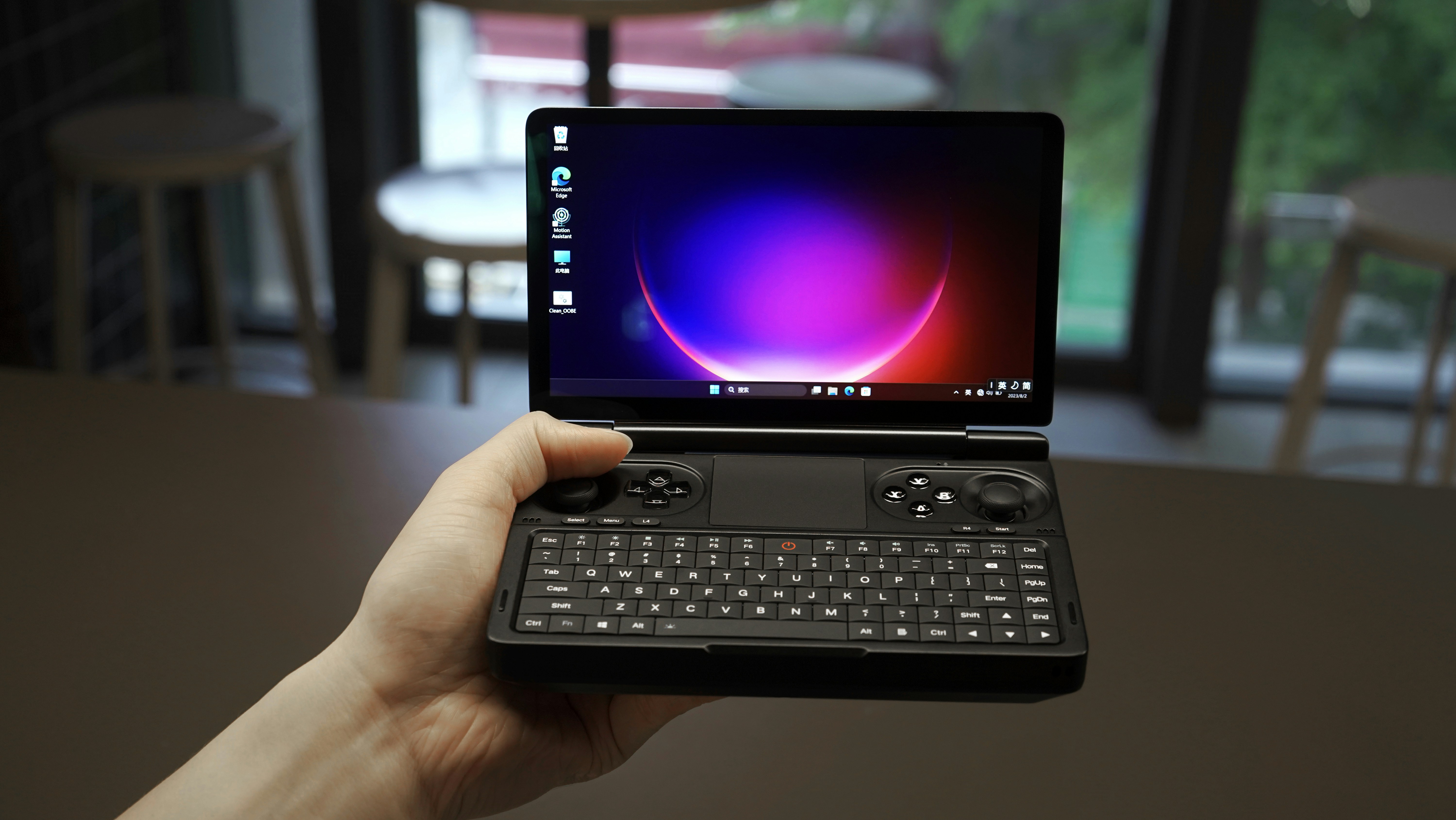 a person holding a laptop with a keyboard on it