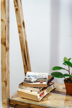 a stack of books sitting on top of a wooden table
