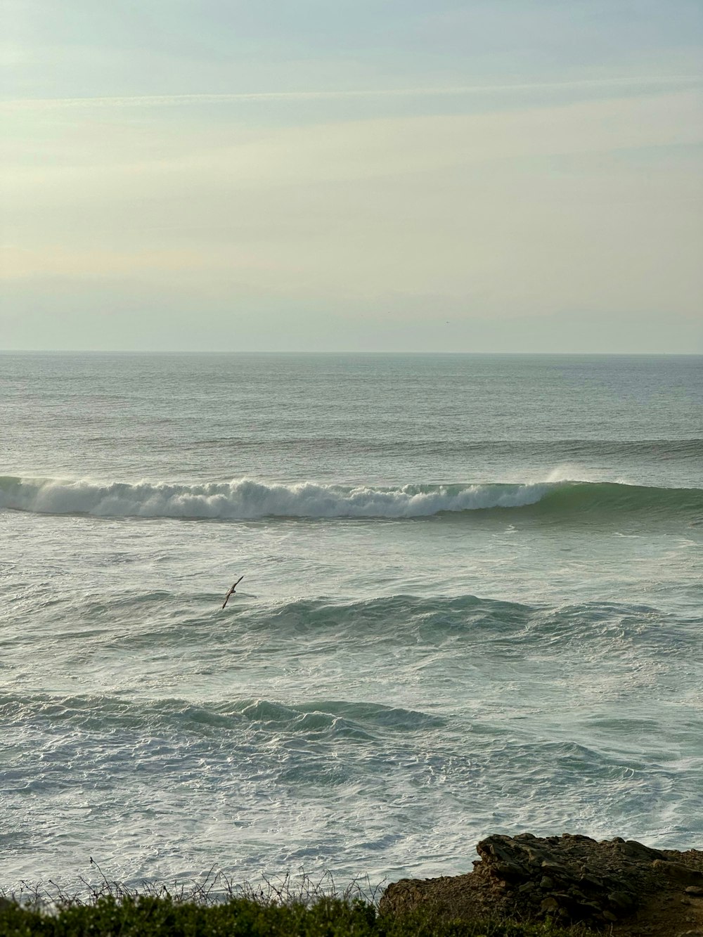 a person riding a surfboard on a wave in the ocean