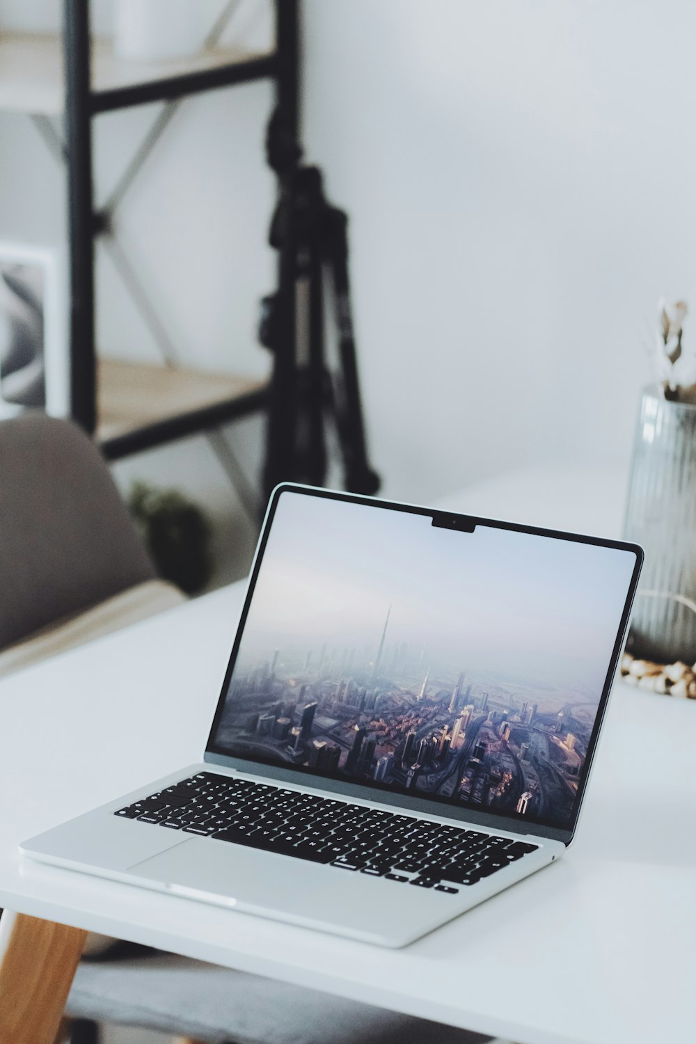 a laptop computer sitting on top of a white desk