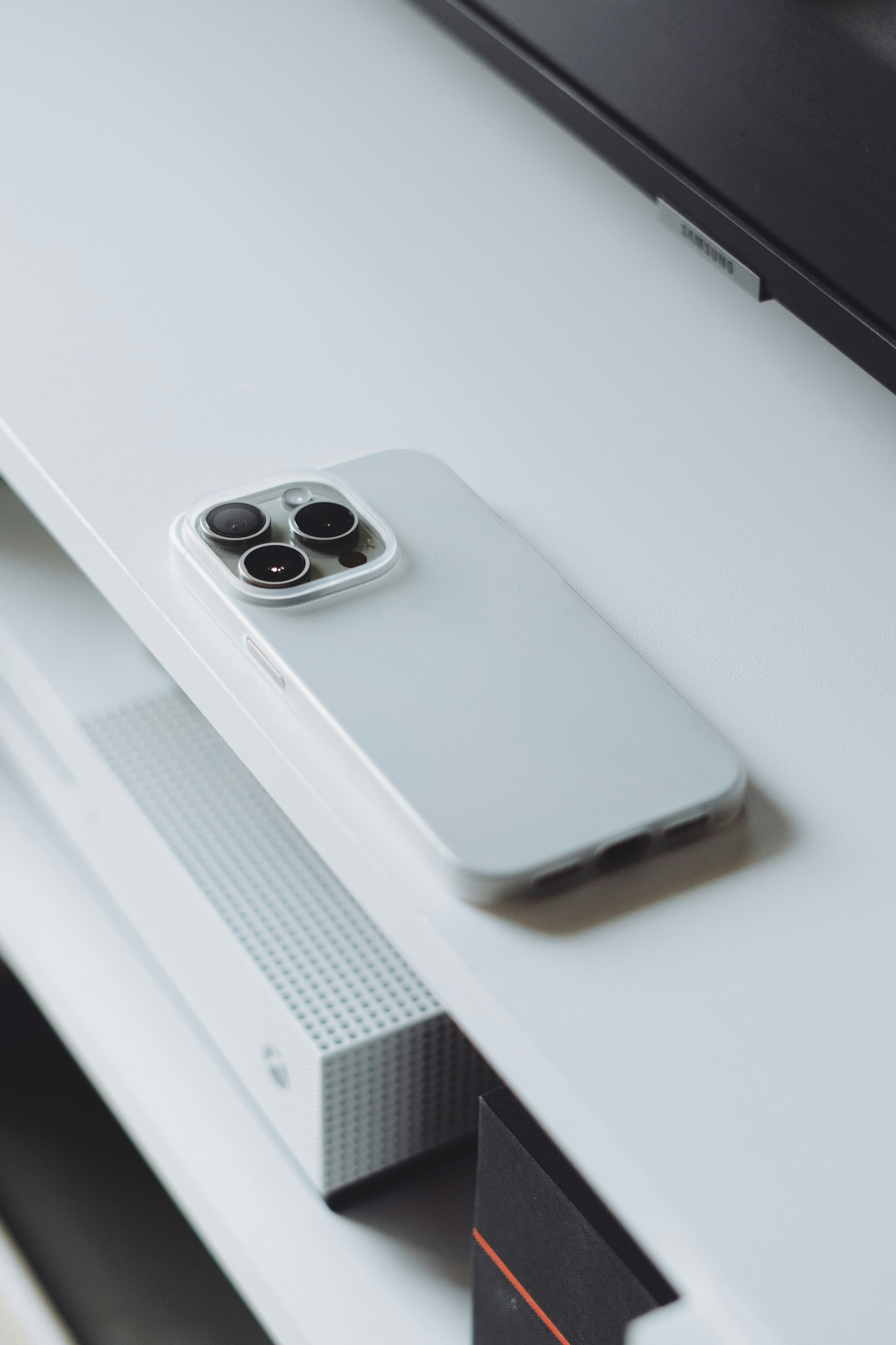a white cell phone sitting on top of a white table