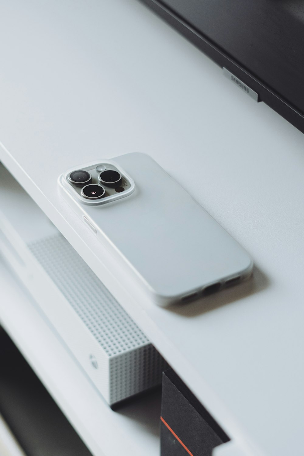 a white cell phone sitting on top of a white table