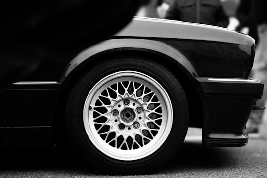 a black and white photo of a wheel on a car