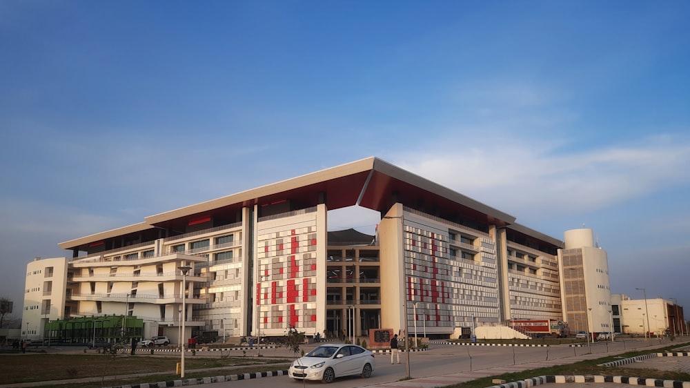 a car parked in front of a large building