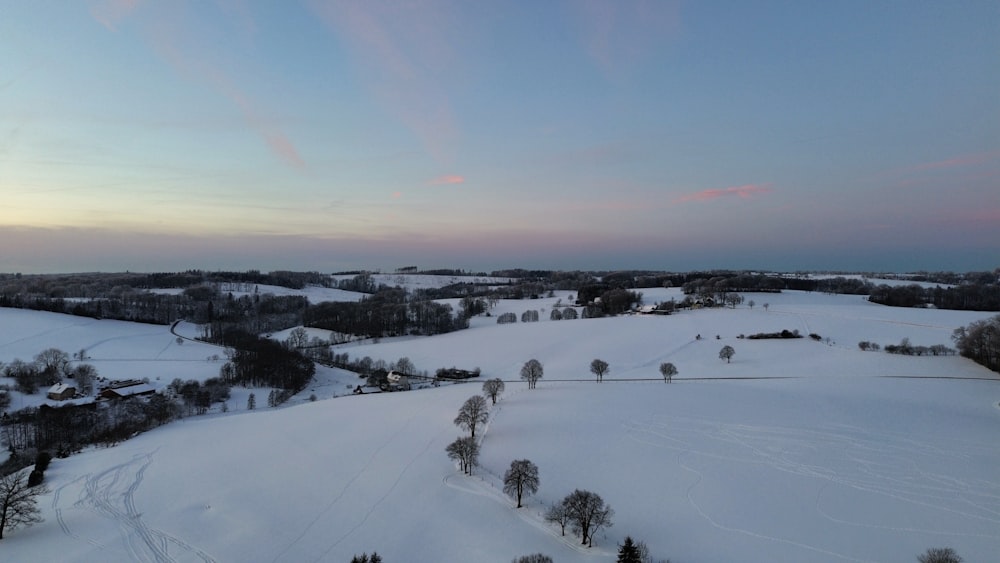 an aerial view of a snow covered field