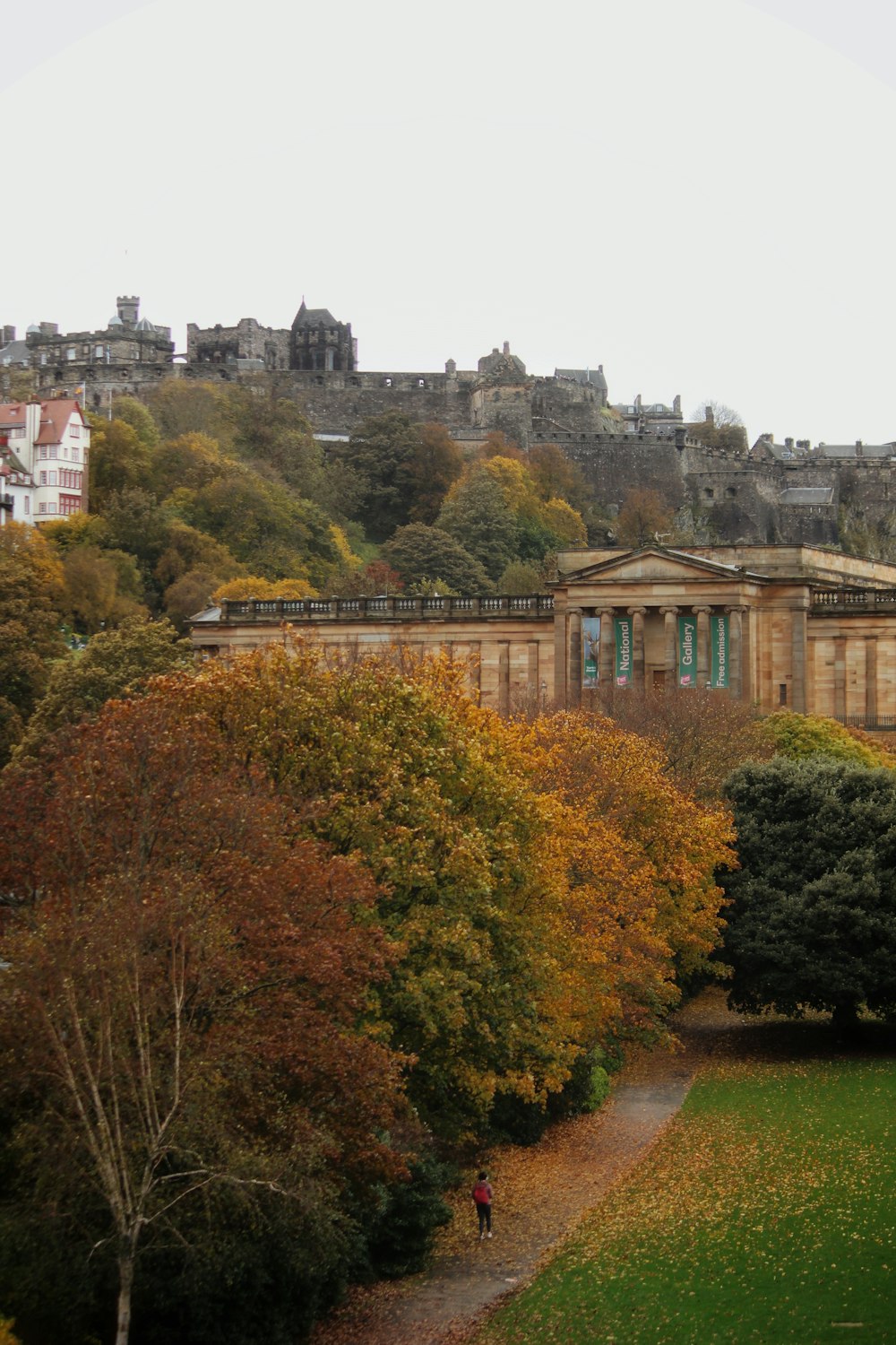 a view of a building from a distance with trees in the foreground