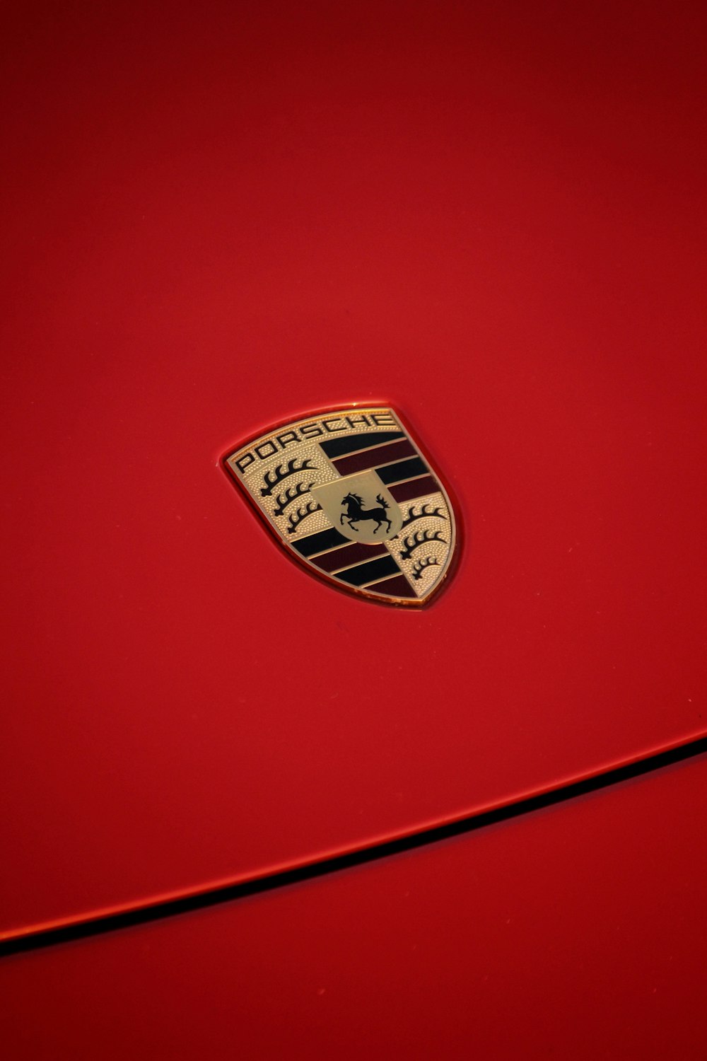 a close up of the emblem on a red car