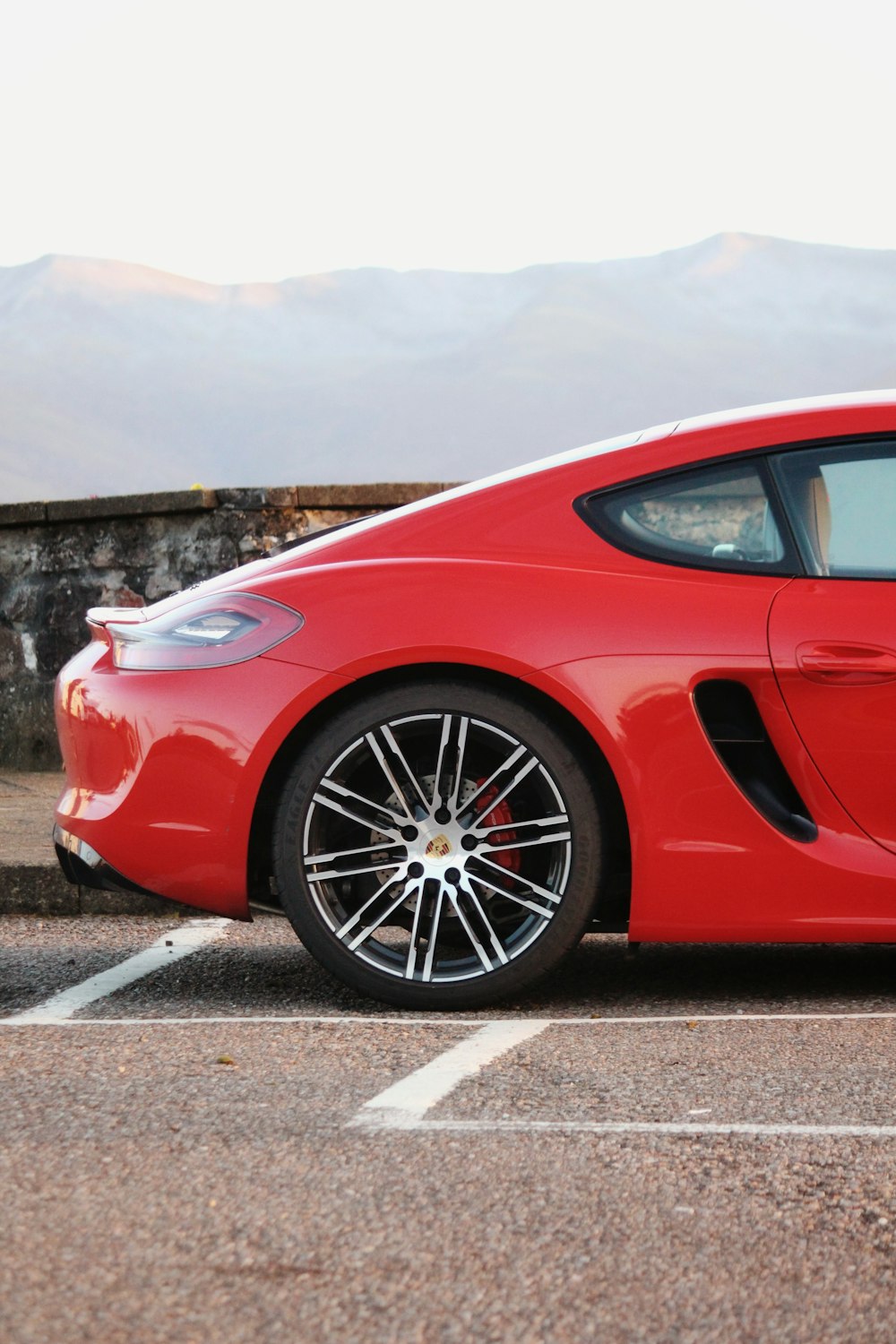 a red sports car parked in a parking lot