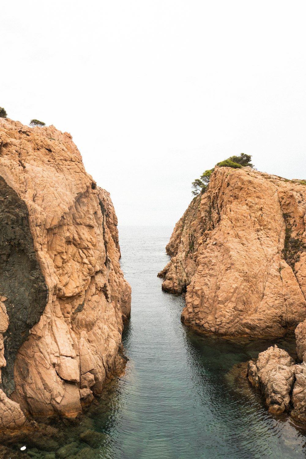 a body of water surrounded by large rocks