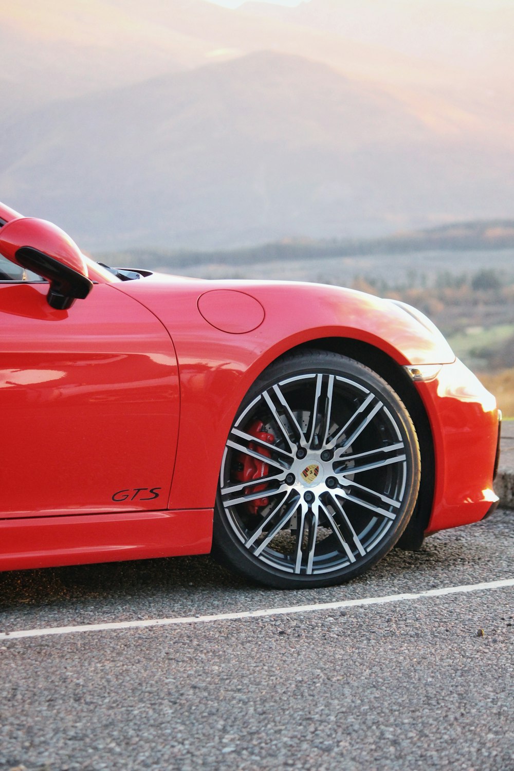 a red sports car parked on the side of the road