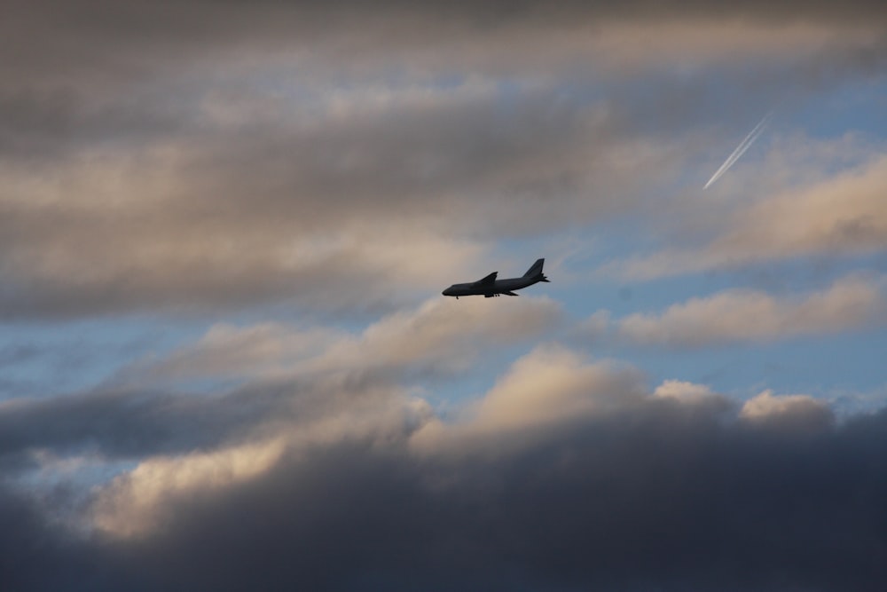 an airplane is flying through a cloudy sky