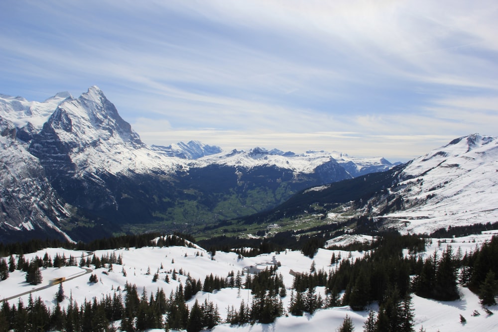 a view of a mountain range with snow on the ground