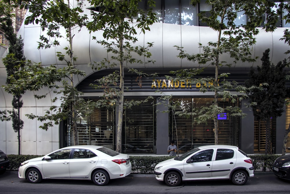 a couple of cars parked in front of a building