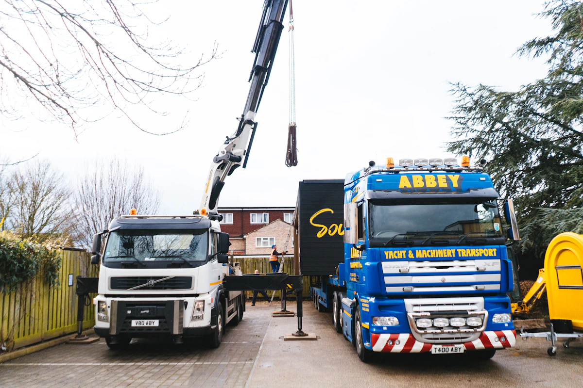 Two work trucks parked side by side in a driveway