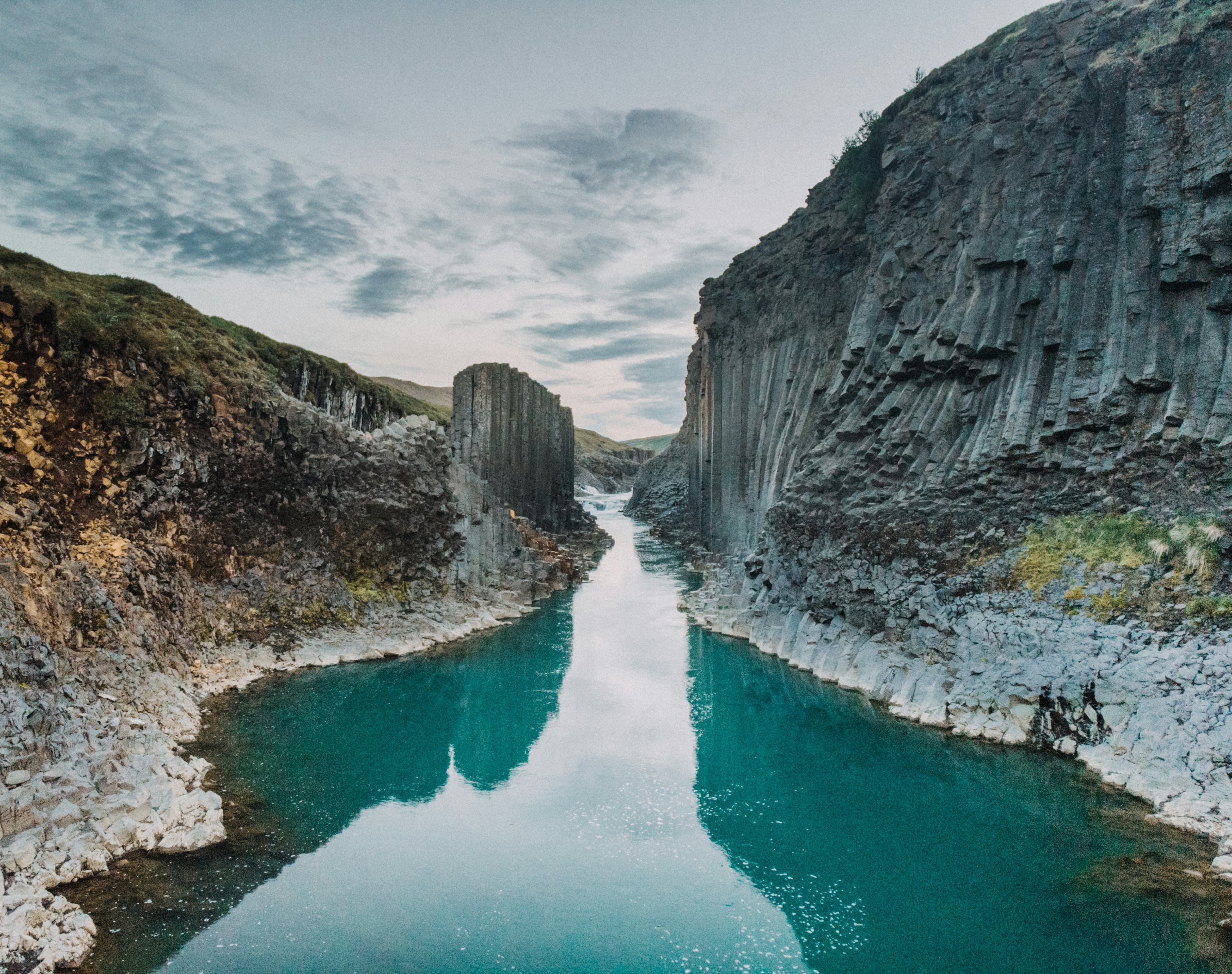 a body of water surrounded by mountains and rocks, 