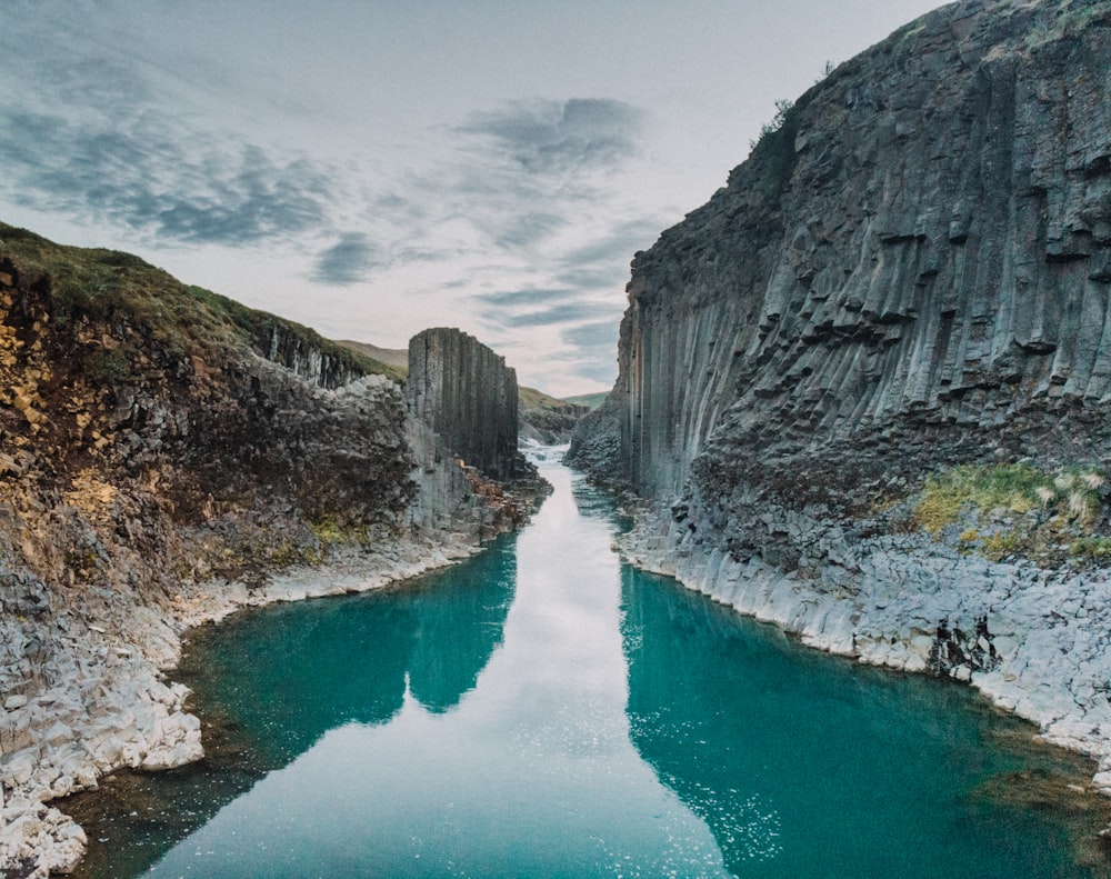 a body of water surrounded by mountains and rocks