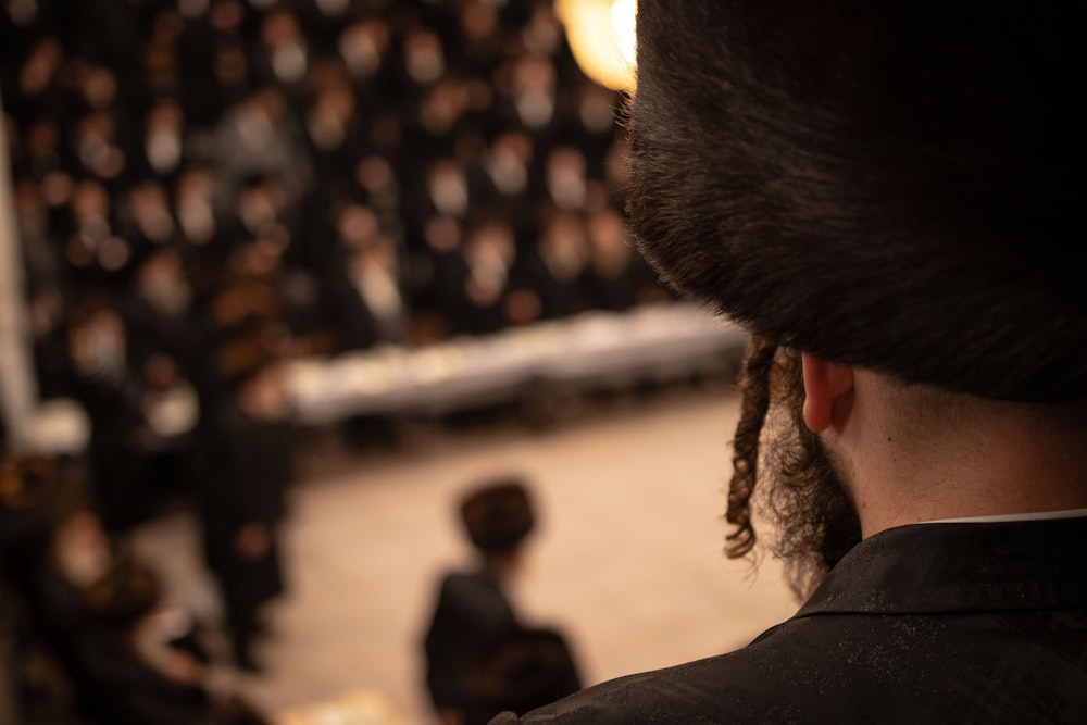 a man with dreadlocks standing in front of an audience