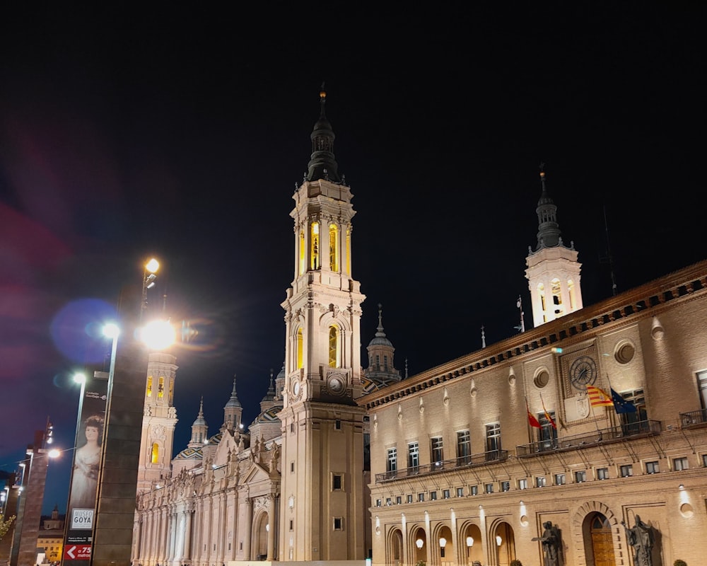 a large building with a clock tower at night