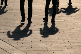 a group of people walking down a sidewalk