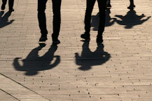 a group of people walking down a sidewalk