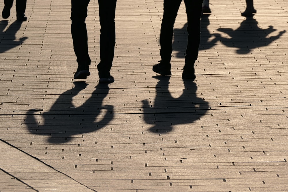 a group of people walking down a sidewalk