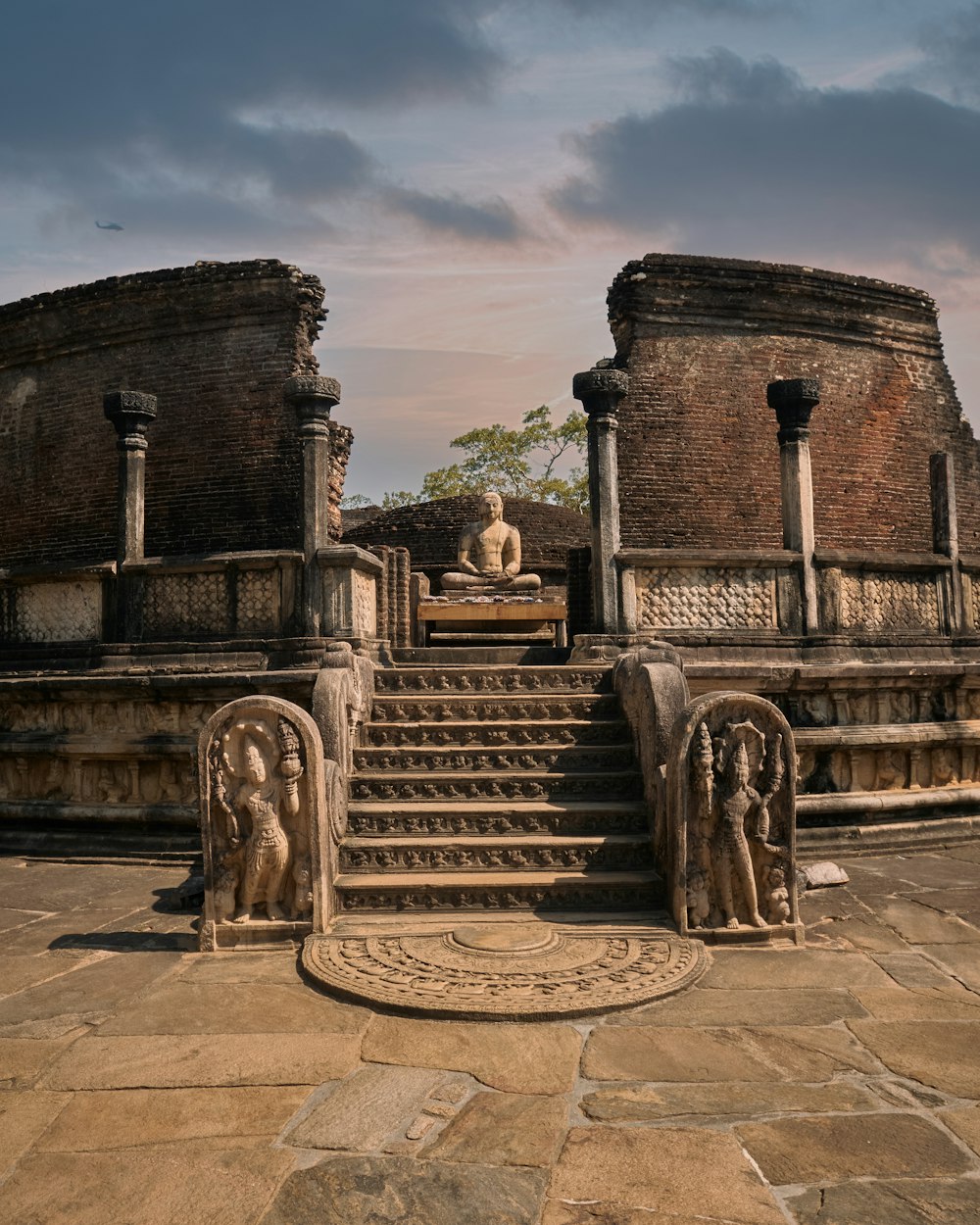 a stone staircase leading up to a statue