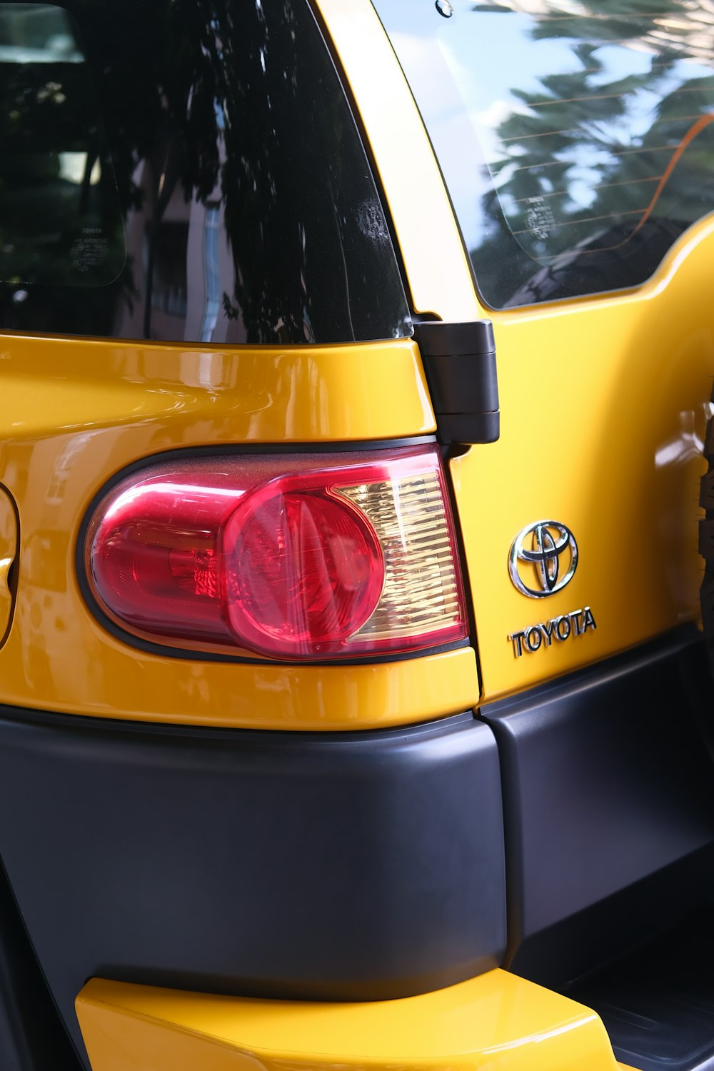 a close up of the tail lights of a yellow car