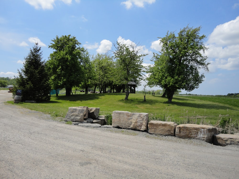 a dirt road that has some rocks on the side of it