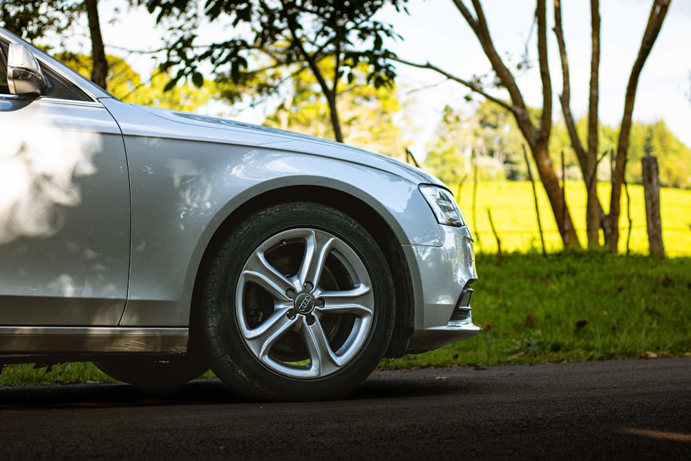 a silver car parked on the side of a road