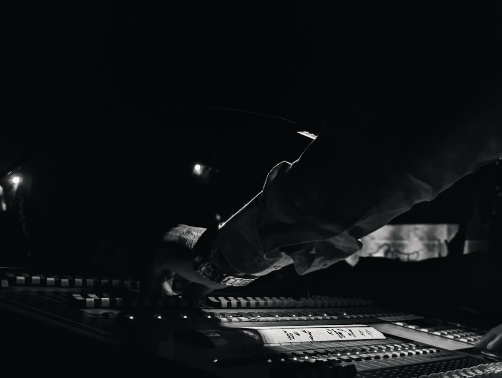a black and white photo of a sound mixing console