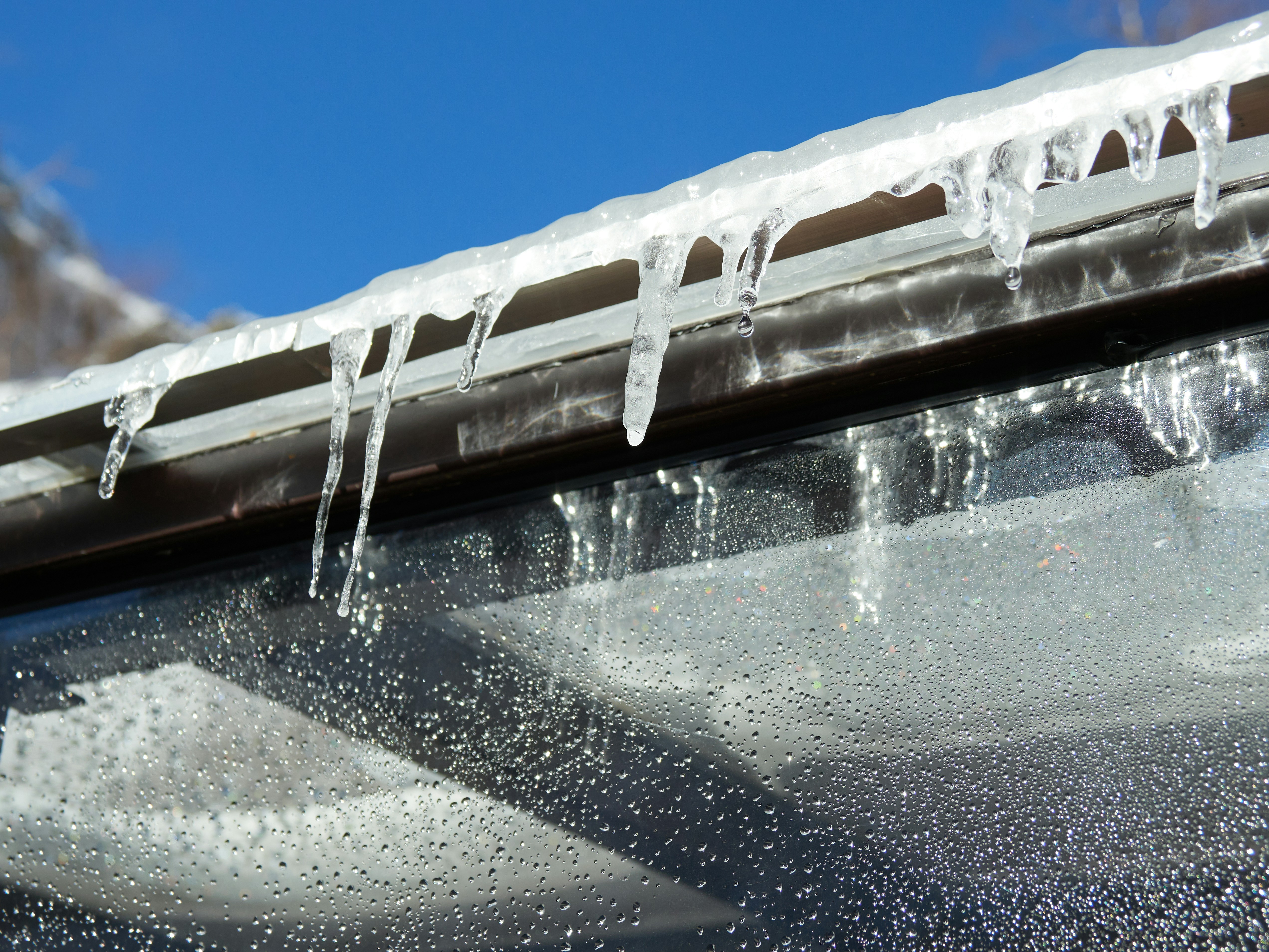 ice dam on a roof gutter - best leaking roof repair rochester ny