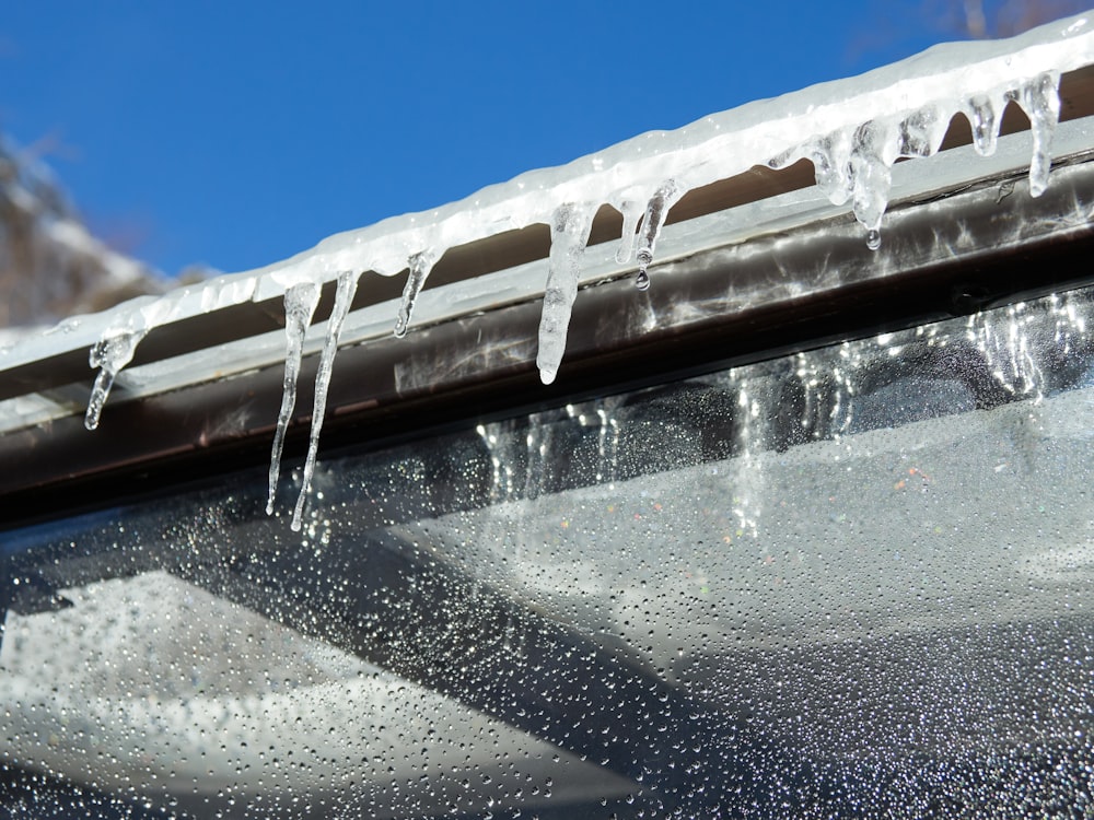 icicles are hanging from a gutter gutter