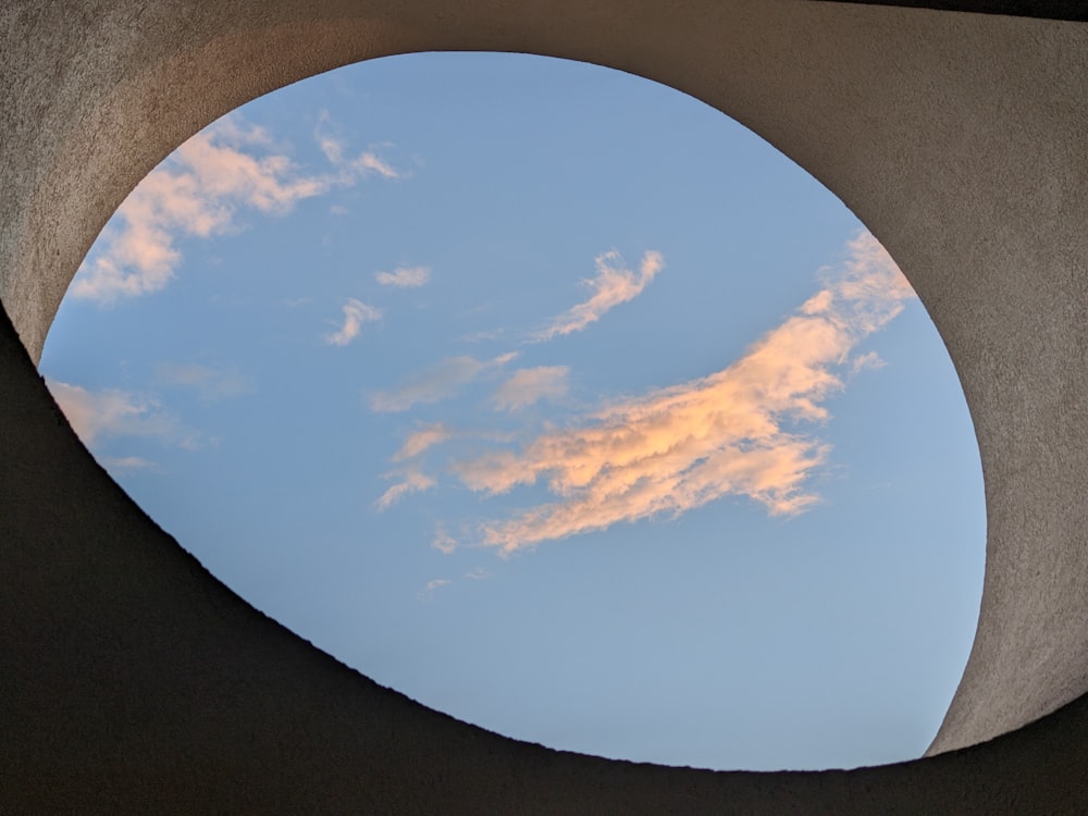 a view of the sky through a circular window