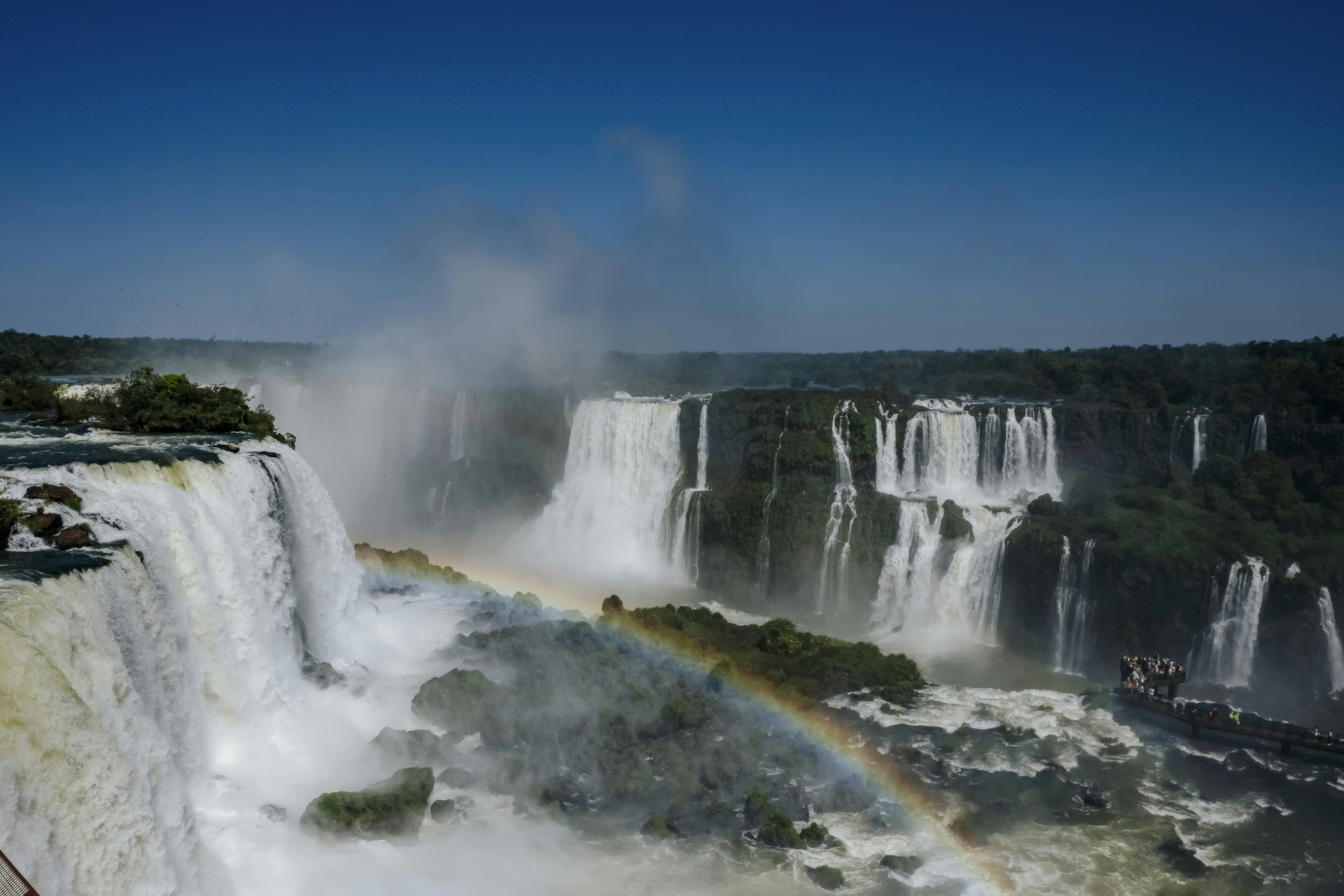 a waterfall with a rainbow in the middle of it