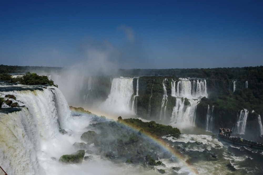 a waterfall with a rainbow in the middle of it