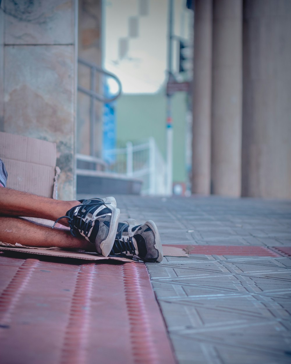 a man sitting on a cardboard box on the ground