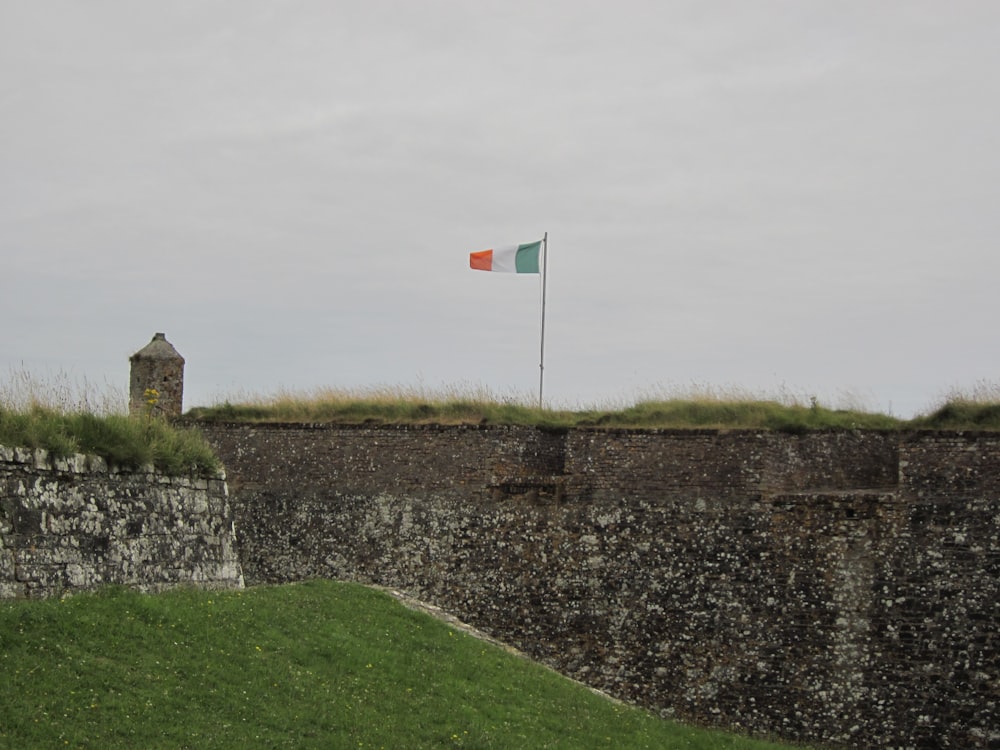 a flag on top of a stone wall